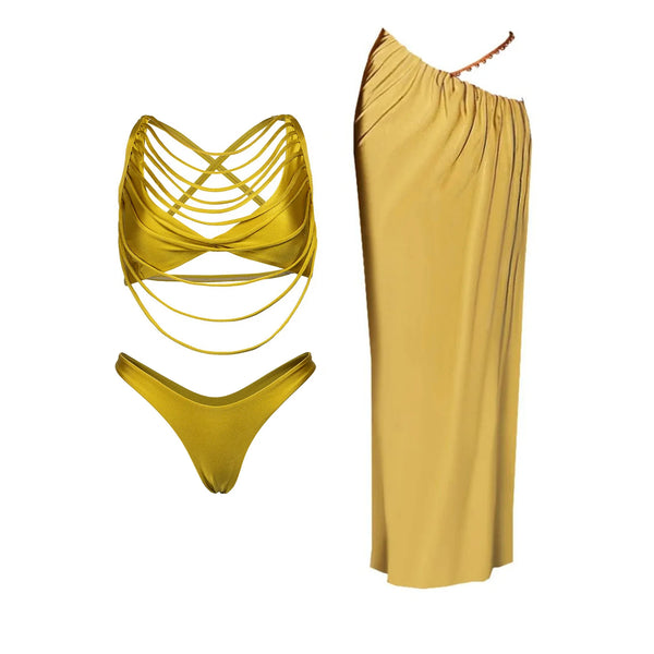 Mustard yellow bikini set and one-shoulder dress on a white background