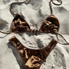 Bronze bikini set on a textured surface