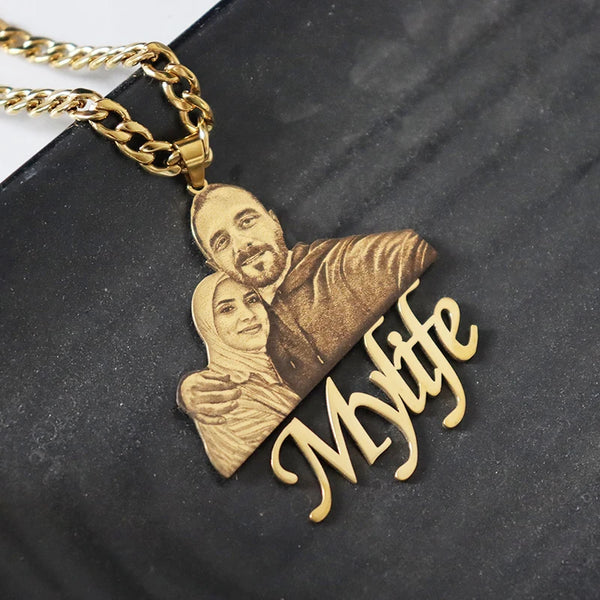 Gold necklace with a pendant featuring a couple and 'My Wife' text on a dark surface