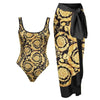 One-piece swimsuit and matching sarong with gold and black floral pattern on a white background