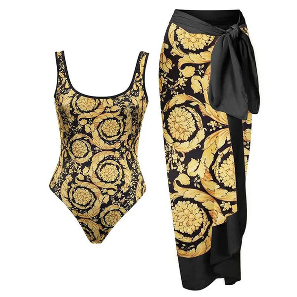 One-piece swimsuit and matching sarong with gold and black floral pattern on a white background