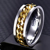 Gold and silver ring with chain design on a dark background