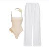 Beige swimsuit with floral details and white pants on a white background