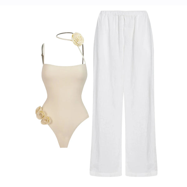 Beige swimsuit with floral details and white pants on a white background