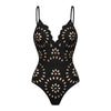 Black swimsuit with cut-out floral patterns on a white background