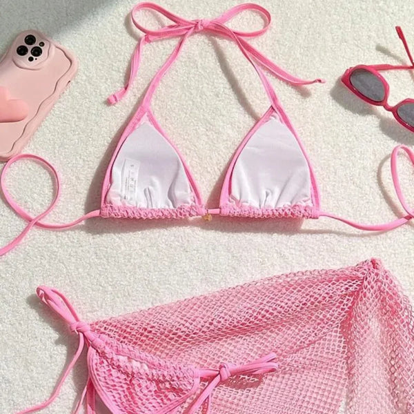 Pink bikini set with mesh string on a light background