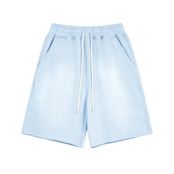 Light blue shorts with drawstring on a white background