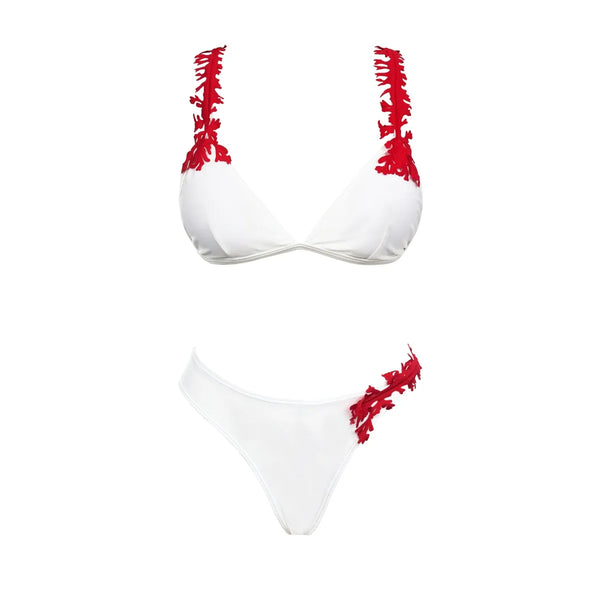 White bikini with red floral patterns on a white background