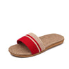 Beige sandal with a red strap on a white background