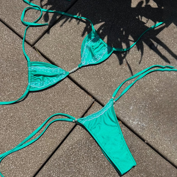 Teal bikini set on a textured surface