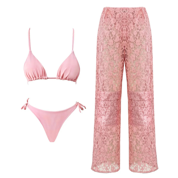 Pink bikini set and lace pants on a white background