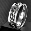 Silver ring with intricate design on a dark background