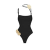 Black swimsuit with floral details on a white background