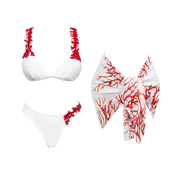 White bikini set with red coral patterns on a white background