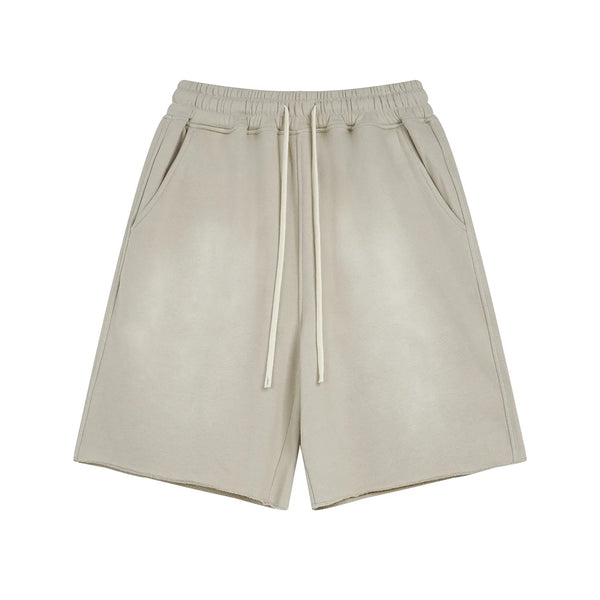 Beige shorts with drawstring on a white background