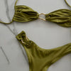 Green bikini set on a marble surface