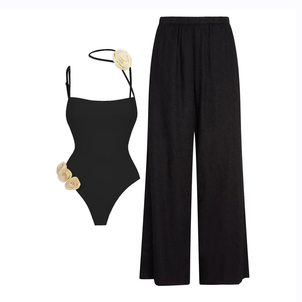 Black swimsuit with floral details and black wide-leg pants on a white background
