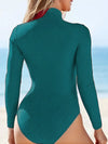 Teal swimsuit worn by a person with a beach background