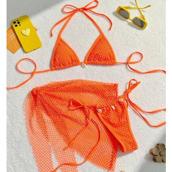 Orange bikini set on a white surface with a phone and sunglasses.