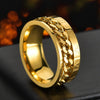 Gold ring with chain design on a dark surface