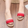 Red and beige sandals on a wooden floor