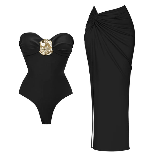 Black strapless swimsuit with gold accent and black sarong on a white background