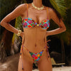 Person wearing a colorful bikini with a tropical background