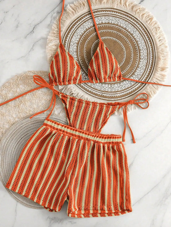 Striped bikini set with ruffled details on a decorative plate
