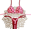 Pink bikini with strawberry pattern on a decorative stand