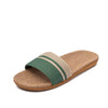 Beige slide sandal with green strap on a white background