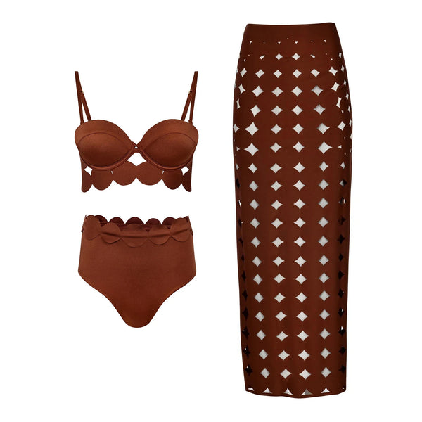 Brown bikini set and patterned skirt on a white background