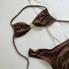 Brown bikini set on a marble surface
