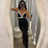 Woman taking a mirror selfie wearing a black dress with white lace details.
