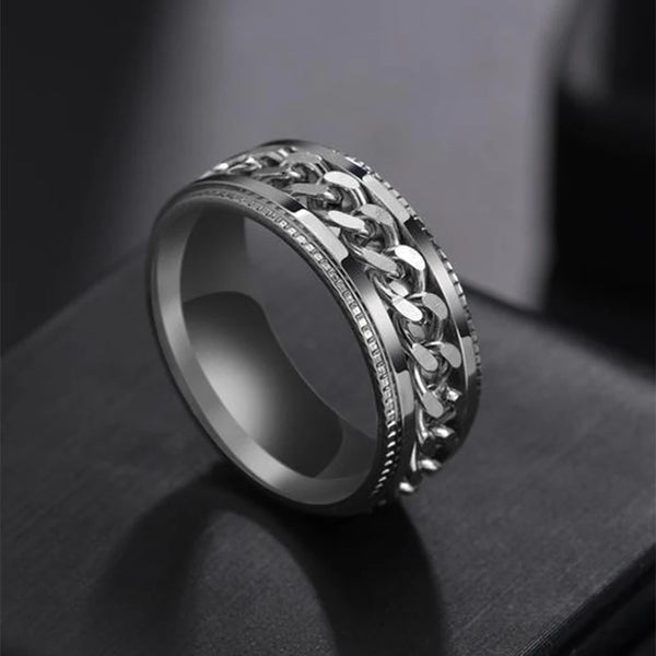 Silver chain ring on a dark surface
