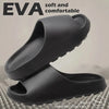 Black EVA slippers with text on a textured background
