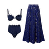 Navy blue bikini set with matching laser-cut skirt on a white background