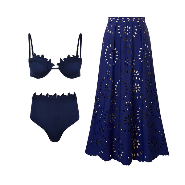 Navy blue bikini set with matching laser-cut skirt on a white background