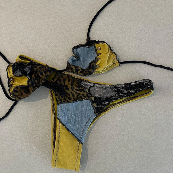 Multicolored bikini bottom with leopard print, denim, and yellow accents on a light background