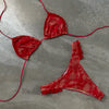 Red bikini set on a gray concrete surface