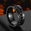 Black metal ring with chain design and Roman numeral details on a dark background