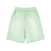 Light green shorts with a drawstring on a white background