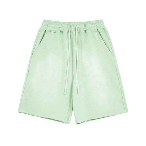Light green shorts with a drawstring on a white background