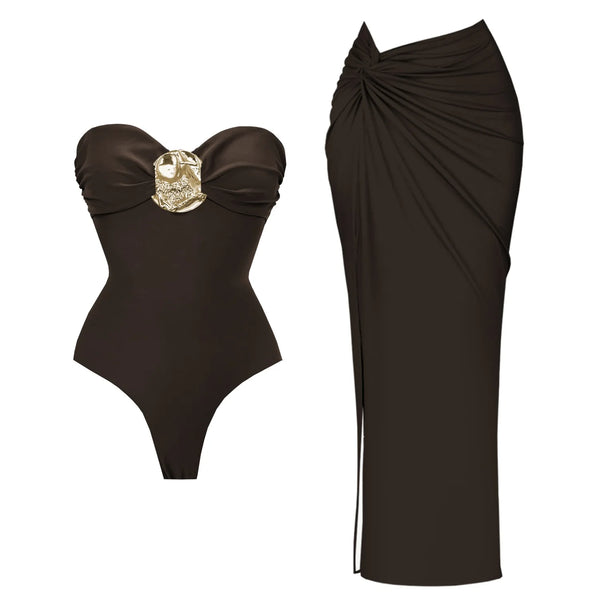 Black strapless swimsuit with gold accent and matching black skirt on a white background