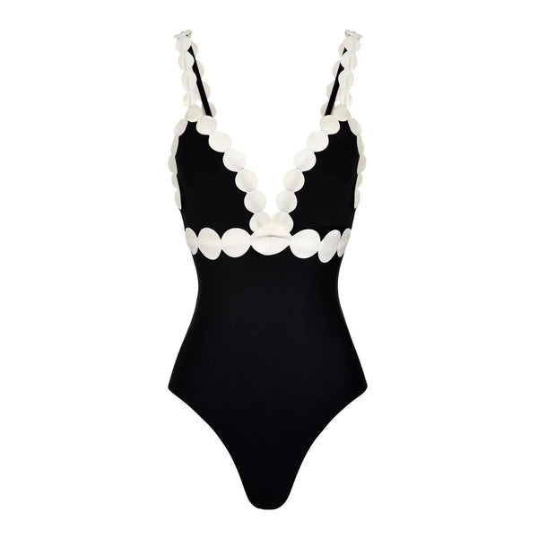 Black swimsuit with white scalloped edges on a white background
