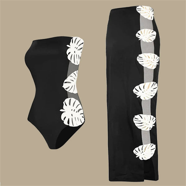 Black swimsuit with white leaf patterns on a beige background