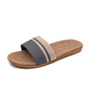 Brown slide sandal with a gray strap on a white background
