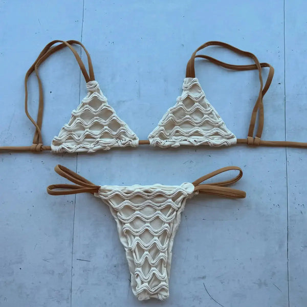 White bikini set with brown straps on a light blue background