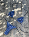 Blue bikini set on a wooden surface