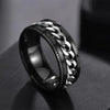 Black and silver chain ring on a dark surface