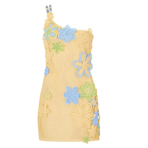 Yellow knitted dress with blue and green floral patterns on a white background